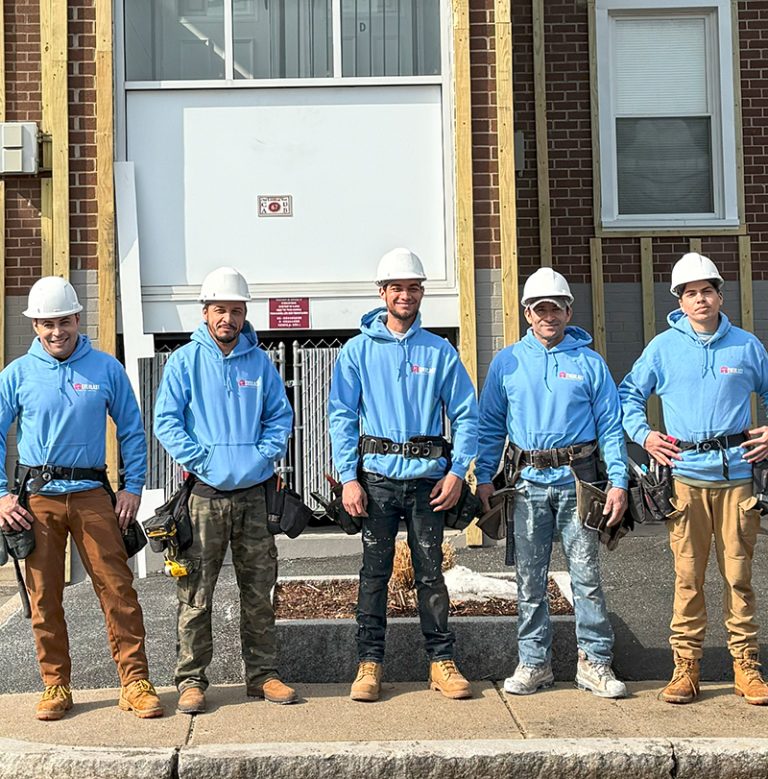 The Everlast General Services crew in hard hats and Everlast hoodies on a job site