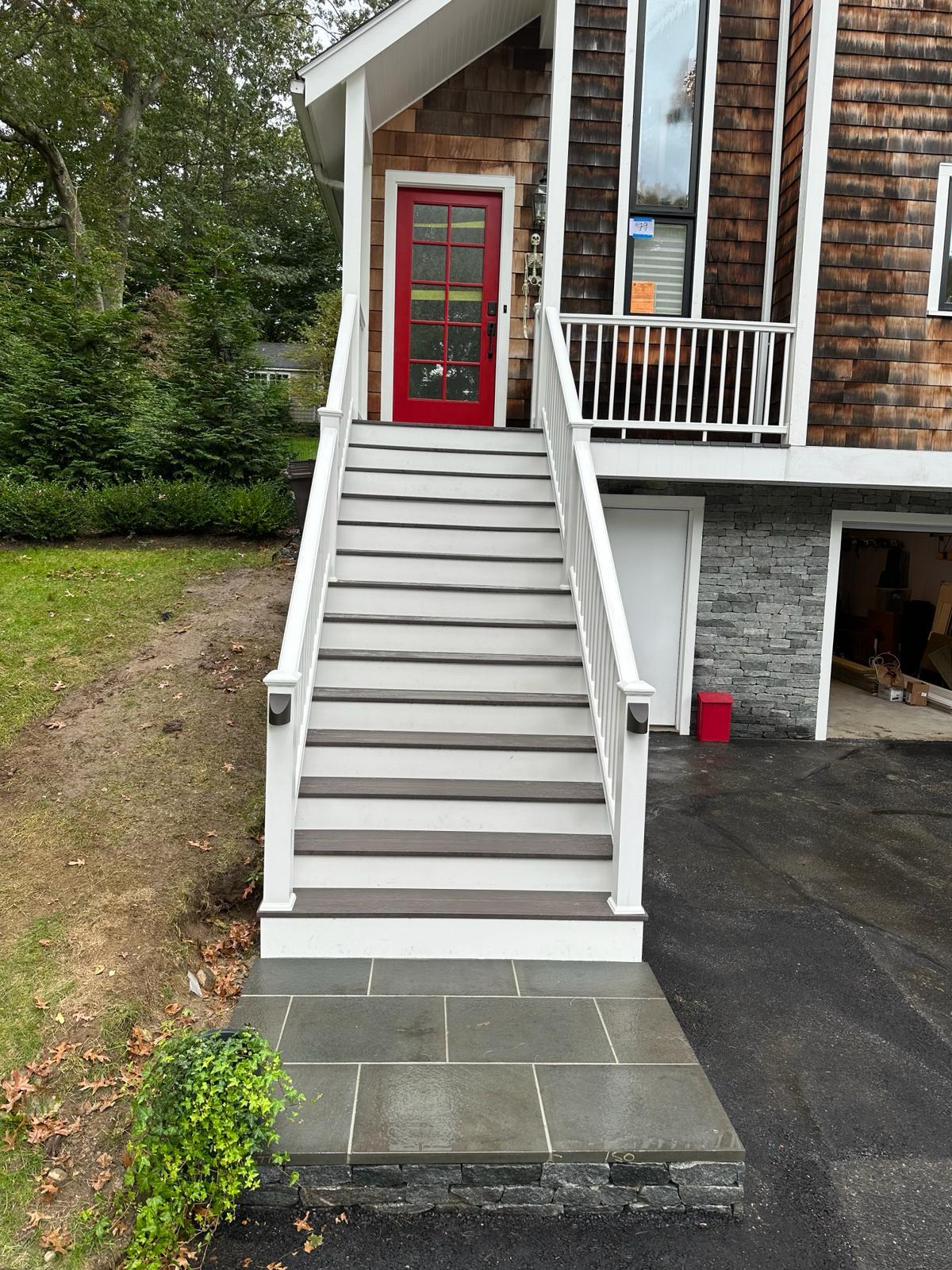 Composite deck staircase with white railings built by Everlast